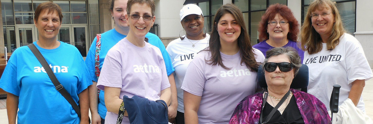 Seven volunteers posing with a client