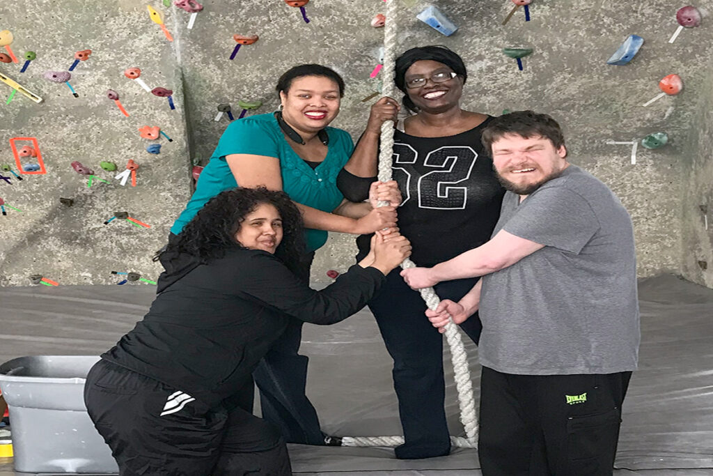 Photo of Monroe clients enjoying a rock climbing activity