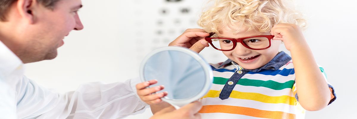 Photo of a preschool-aged boy being fit for glasses