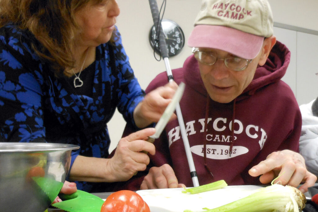 Photo of a client and an instructor in a vision rehabilitation therapy class