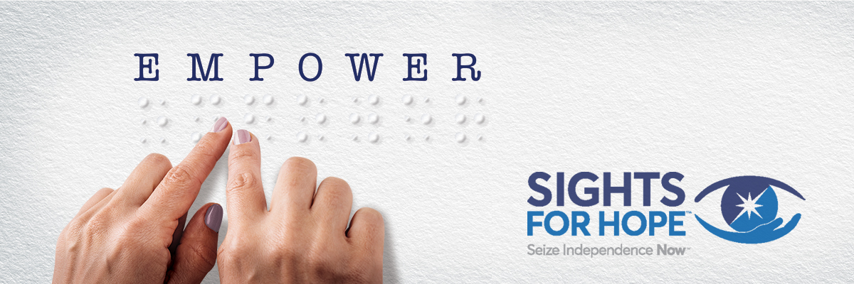 Image of two hands feeling letters in braille that spell out the word EMPOWER