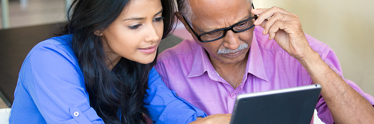 Image of a woman helping an older man with glasses