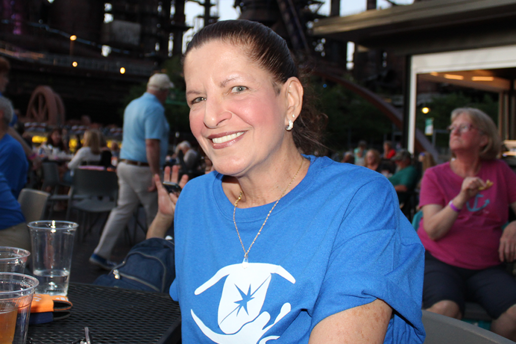 A Sights for Hope client seated at an outdoor event